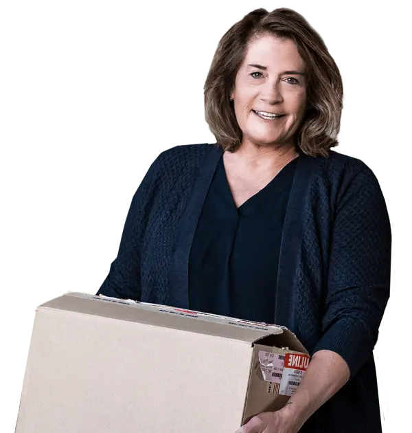 Linda holding a moving box